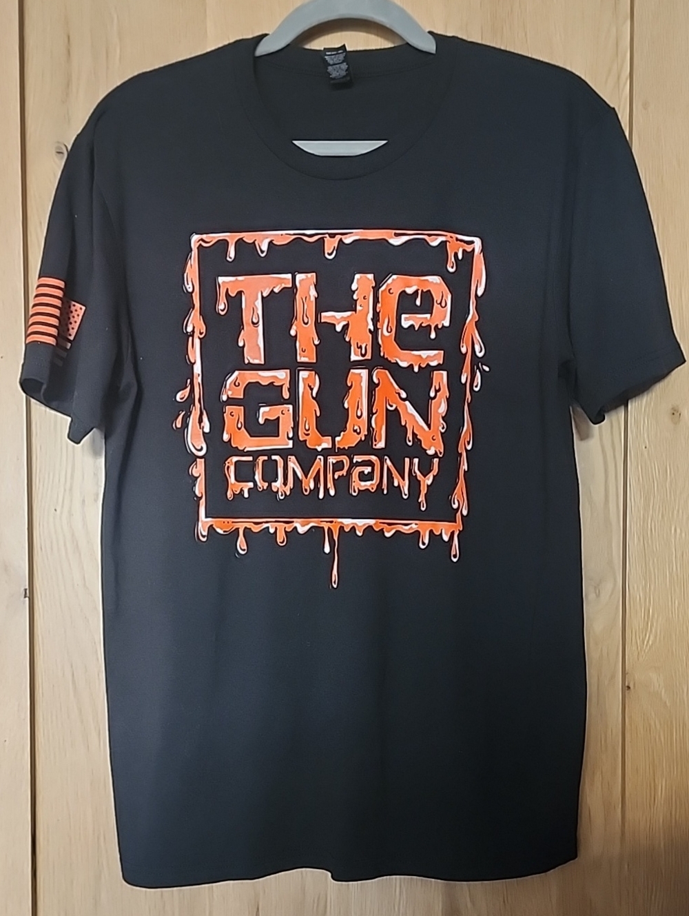 District Black Short-Sleeve Tee with Orange Drip Logo. #B0110